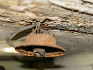 old iron lamp on the ceiling of an old hangar, blurred background