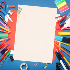 Stationery and blank paper on blue background. Education concept with copy space for your ideas. Flat lay, top view.