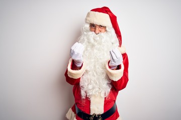 Middle age handsome man wearing Santa costume standing over isolated white background doing money gesture with hands, asking for salary payment, millionaire business