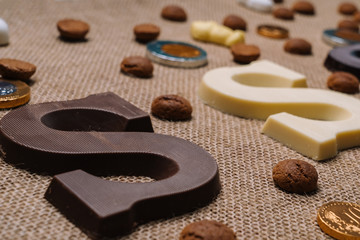Dutch holiday Sinterklaas.Burlap sack and traditional food - pepernoten, chocolate letter, sweets strooigoed and carrots for horse. Concept for children party in Saint Nicolas day five december.
