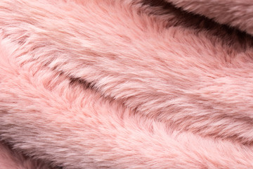 Pink fluffy faux fur texture and background.