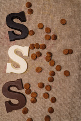 Dutch holiday Sinterklaas.Burlap sack and traditional food - pepernoten, chocolate letter, sweets strooigoed and carrots for horse. Concept for children party in Saint Nicolas day five december.