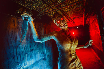 Scary undead zombie in the dark corridor. Halloween theme.