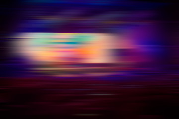 Abstract blurred background of multi-colored lines and dark purple horizontal lines and bright light spots.