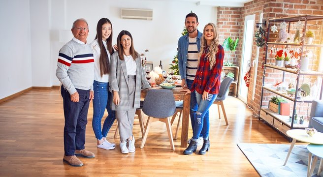 Beautiful family smiling happy and confident. Standing posing with tree celebrating Christmas at home