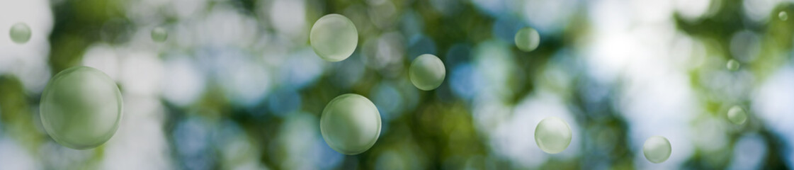 Image of green stylized balls on a beautiful abstract blurred natural background