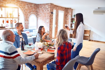 Beautiful family meeting smiling happy and confident. Speaking speech eating roasted turkey celebrating Christmas at home