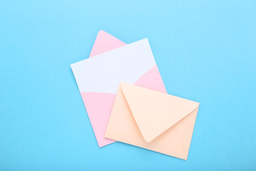 Colorful paper envelopes on blue background