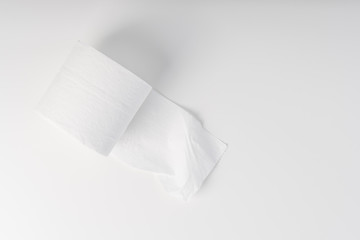 Opened roll of toilet paper on a white table. Hygiene concept