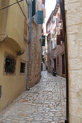 Romantic travel location, picturesque paved old narrow stone street in the Old Town of Rovinj, Croatia. Europe.