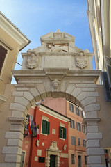 Stone sculptures decorate old gate of a Venetian town on the shores of Adriatic sea, Rovinj, Croatia.