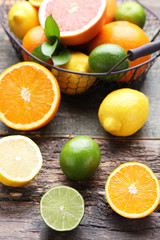 Naklejka na ściany i meble Citrus fruits in basket on wooden table
