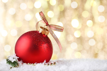 Fototapeta na wymiar Christmas bauble with ribbon bow on blurred background