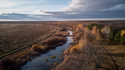 View of the autumn forest river from the air