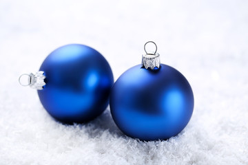 Christmas baubles on white snow