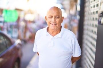 Obraz premium Senior handsome man smiling happy and confident. Standing with smile on face at town street