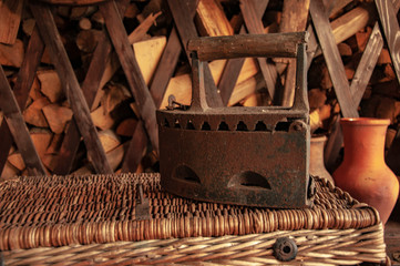 Old metal rusty vintage iron on coals.The old device for Ironing clothes