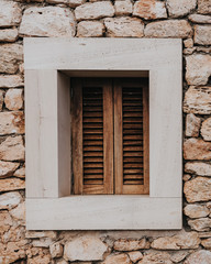 Fototapeta na wymiar window of a rustic house in an ancient Mediterranean town
