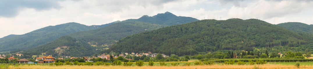 Thunderhead covers the Balkans. Downpour is approaching agricultural land. Villages, fields and...