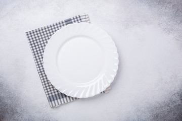Empty white plate and linen napkin on stone background Copy space Top view - Image