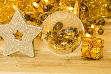Fototapeta na wymiar glass ball with silver star and golden package