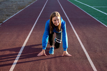 young girl stands at the start on a treadmill, woman runner exercise on the street