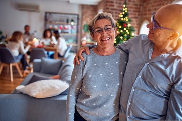 Family and friends dining at home celebrating christmas eve with traditional food and decoration,...