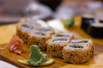 Tataki maguro maki rolls with ginger and wasabi. Delicious japanese food on wooden plate