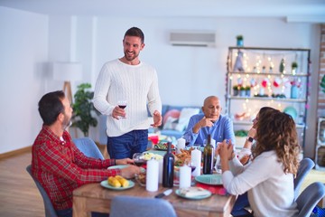 Beautiful family smiling happy and confident. Man speaking a speech celebrating Christmas at home