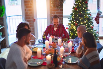 Beautiful family smiling happy and confident. Eating roasted turkey celebrating Christmas at home