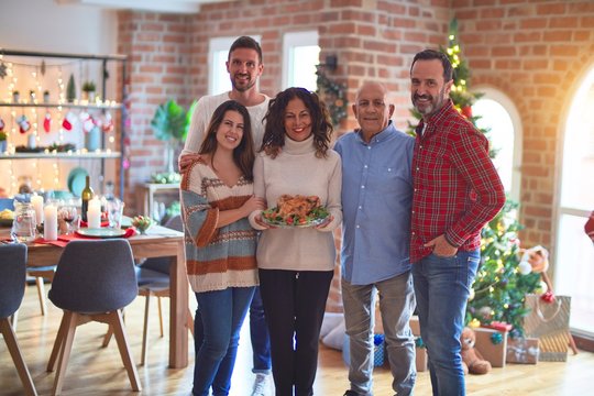 Beautiful family smiling happy and confident. Standing and posing with tree celebrating Christmas at home