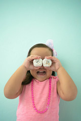 I can see you: Happy girl playing with donuts	