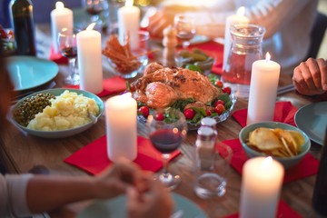 Beautiful family smiling happy and confident. Eating roasted turkey celebrating Thanksgiving Day at home