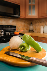 Chopping green peppers and onions