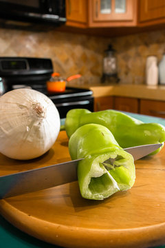 Chopping green peppers and onions