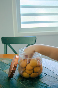 Child's hand picking a cookie