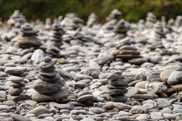 Pile of rocks that mark the way for hikers along a river.
