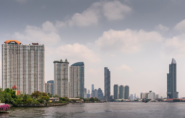 Bangkok city, Thailand - March 17, 2019: Chao Phraya River. Plenty of skyscrapers, upriver look...