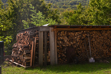 Chopped firewood for the fireplace. Autumn atmosphere in the mountains.