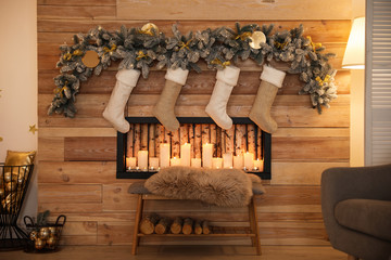 Stylish room interior with decorative fireplace. Christmas time