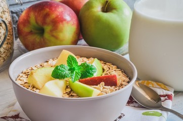 Sweet delicious healthy breakfast. Porridge with apples on the kitchen table.