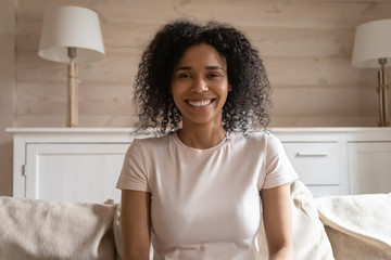 Happy african american woman video calling to friend or parents.