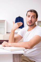 Young male student preparing for exams at home