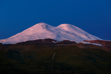 Fototapeta premium Dawn over the snowy peaks of Mount Elbrus. North Caucasus.