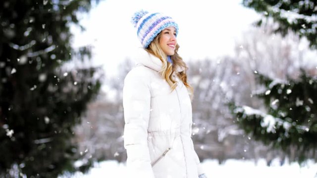 people, season and leisure concept - happy smiling woman walking along winter park