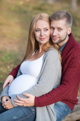 A portrait of young married couple expecting a baby