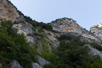 Fototapeta na wymiar Rock wall on the shores of Lake Garda