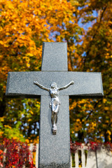 Monument on the gravestone. Tombstone with a big Christian cross. All Saints Day. Christian...