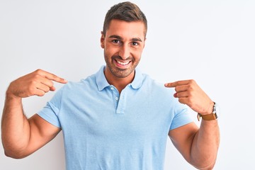 Young handsome elegant man wearing blue t-shirt over isolated background looking confident with...