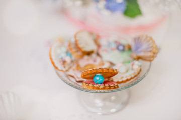 Candy bar, maritime cookies and pearl macarons. Catering buffet style.	